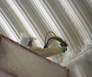 Applying Polyurethane Foam Insulation to the inside of an agricultural home